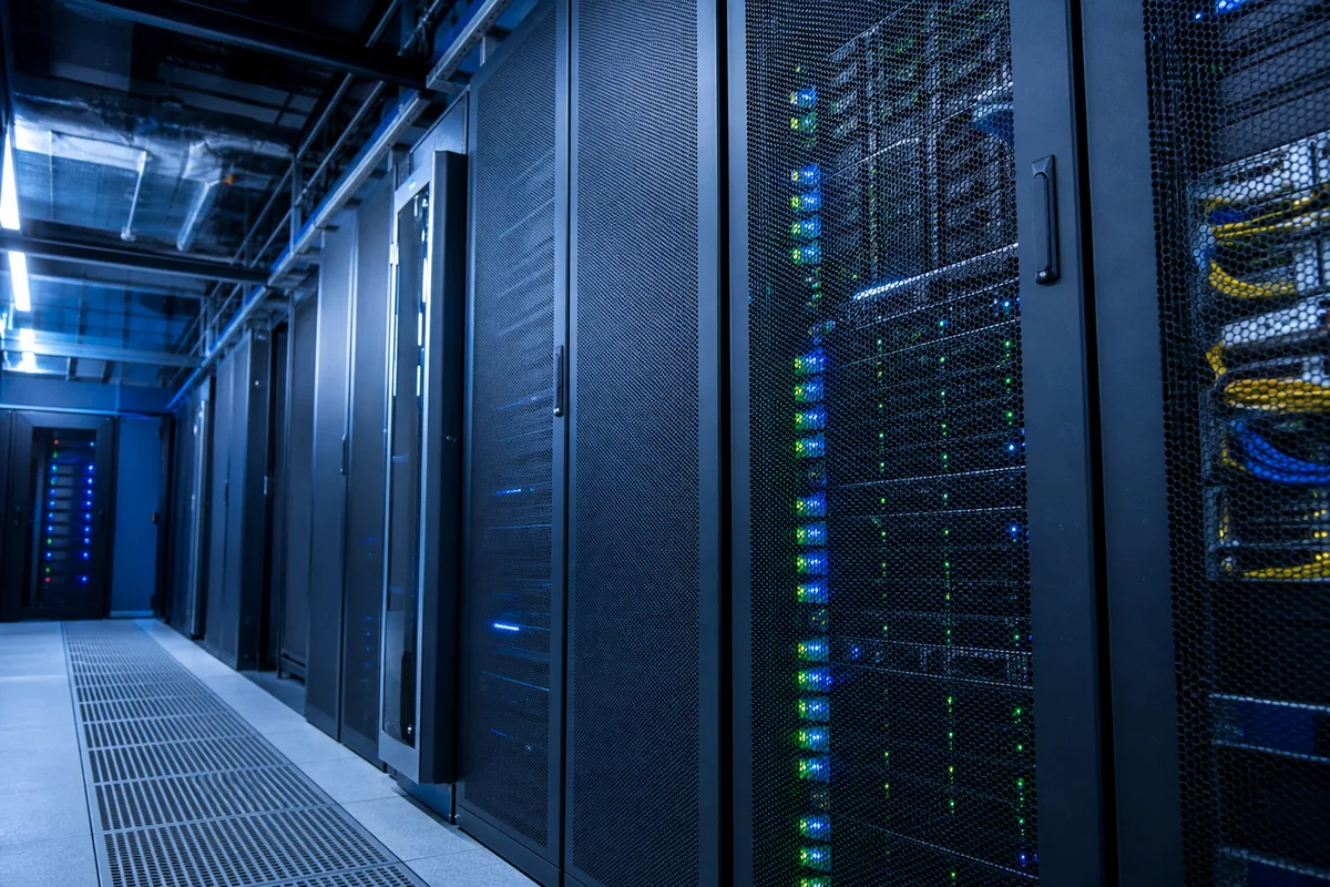 Serveurs informatiques dans une baie de datacenter avec câbles réseau et voyants lumineux